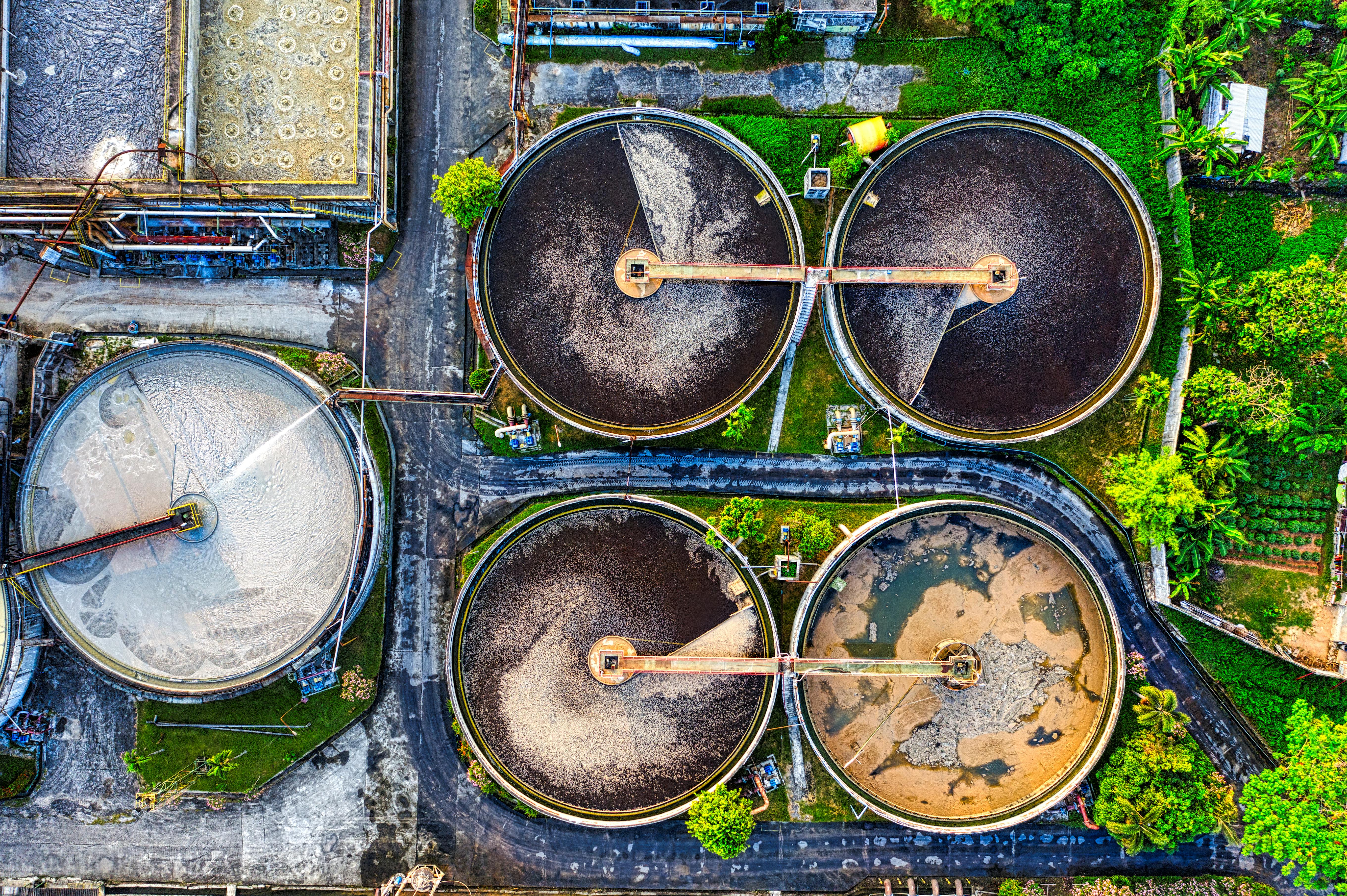 Aerial shot of a water treatment plant in Serang, Indonesia with circular tanks.