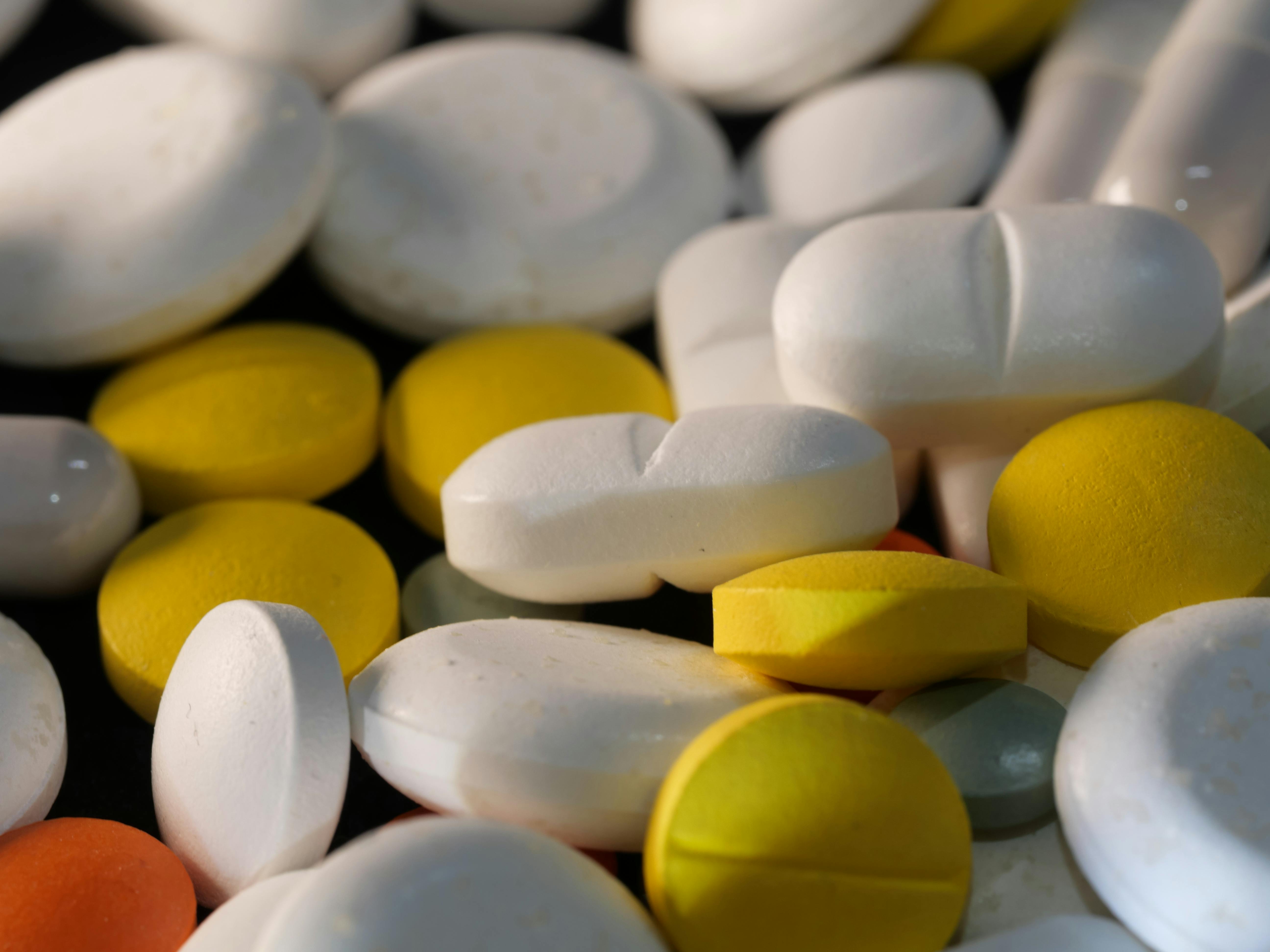 Close-up image of various colored tablets showcasing pharmaceutical diversity.